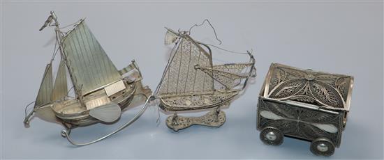 A Dutch white metal miniature model sailing boat, a white metal filligree miniature sailing boat and similar casket on wheels.